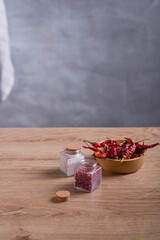 Fresh vegetables, herbs and cereals lie on a wooden countertop in the kitchen