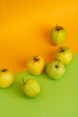 Green apples on yellow and green background