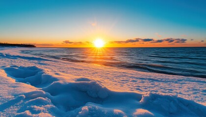 A serene winter sunset over a snowy beach, with the sun's warm glow reflecting on the ocean waves, creating a picturesque and tranquil scene.