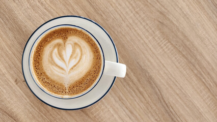 Top view latte art coffee on wood background