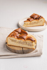A piece of yeast pie with meat filling on a light background
