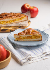 A piece of yeast pie with apple filling on a light background
