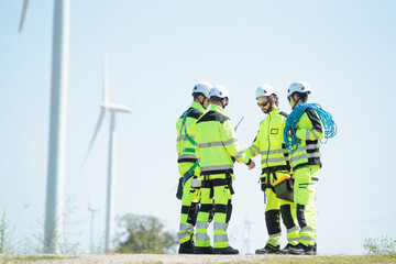 Team of electrical engineer is perform the inspection and maintenance of electric generating windmill turbine.