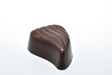 Chocolate candy with water drop shaped filling on white background.