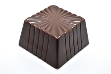 Square shaped chocolate candy with filling on white background.