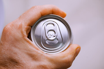 close-up. Men's hands with a aluminum can of beer. Convenient packaging for drinks.
