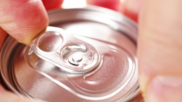 close-up. Men's hands open a aluminum can of beer. Convenient packaging for drinks.
