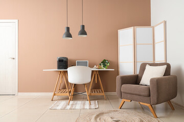 Interior of office with workplace, armchair and portable power station