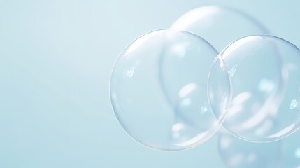 Fototapeta premium Three clear, round bubbles floating in the air. The bubbles are positioned at different angles, creating a sense of depth and movement. Scene is light and playful