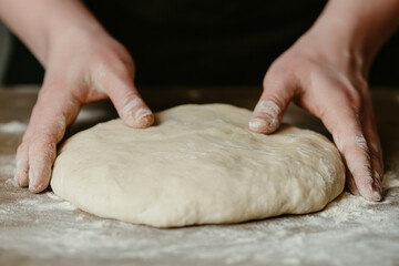 Obraz premium A person is making a dough with their hands