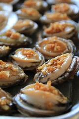 Grilled Shellfish with Garlic Topping on a Barbecue Grill