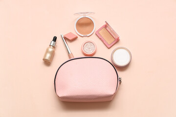 Set of cosmetics and cosmetic bag on pink background