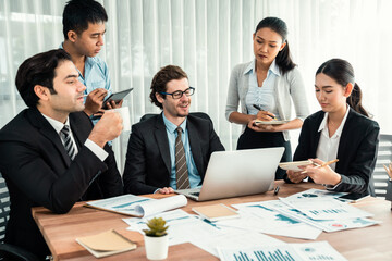 Diverse group of business analyst team analyzing financial data report paper on office table. Chart and graph dashboard by business intelligence analysis for strategic marketing planning Habiliment