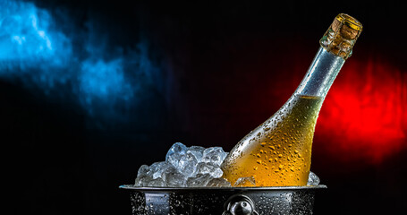 Bottle of sparkiling wine in bucket with crushed ice.