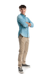 side view of proud young man crossing arms and smiling