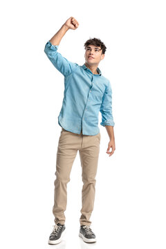cheerful young student with fist raised up celebrating the victory
