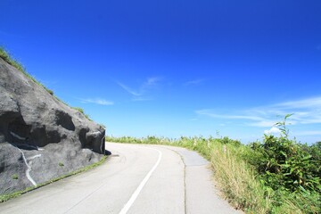 Serene Mountain Road with Clear Blue Sky