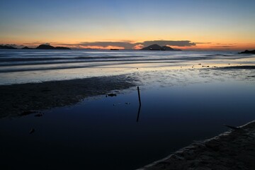 Serene Coastal Sunset with Vibrant Sky Reflections, Hong Kong