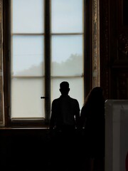 silhouette of a person in a window