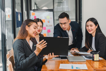 Professional team collaborating in modern office, discussing project details and sharing ideas. atmosphere is focused and engaging, showcasing teamwork and communication