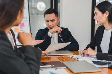 group of professionals engaged in serious discussion during meeting, showcasing expressions of concern and contemplation