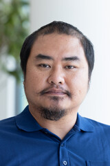 Fototapeta premium Face portrait of middel aged, plus-sized Asian man, with a bit of hair loss as a sign of aging