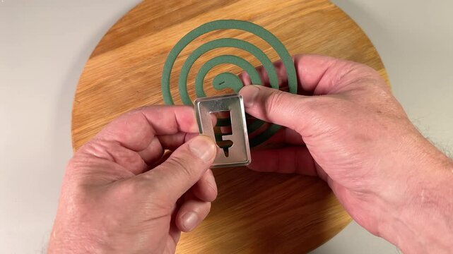 Installation of fumigating mosquito coil on a metal stand