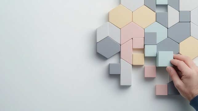 Hands arranging blocks into upward arrow, representing goaloriented mindset