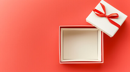 A white box with a red ribbon is open on a red background. The box is empty, but the red ribbon gives the impression of a gift. The red background adds a sense of warmth and excitement to the scene