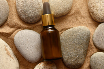 Natural cosmetic oil on stones. Spa therapy. Top view.