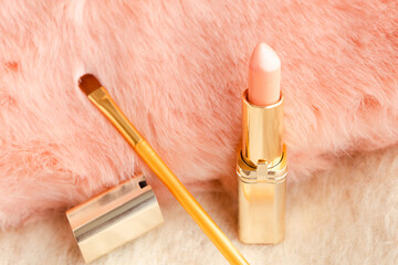 Pink lipstick on pink furry background. Beauty and cosmetics background. Decorative cosmetics,...