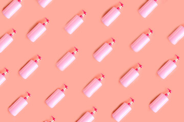 Seamless pattern of bottles with pink dishwashing liquid on pink background. Template for designer