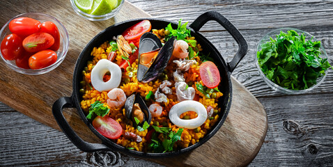 Seafood paella served in a cast iron pan
