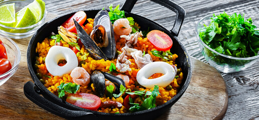 Seafood paella served in a cast iron pan