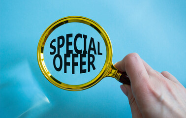 Special offer symbol. Concept word Special offer on wooden blocks. Businessman hand. Beautiful blue...