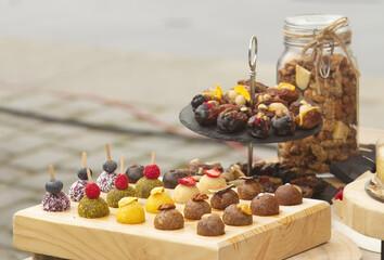 Selling raw desserts at street farmers market, no-bake raw desserts in the shape of balls for sale at the street food market.