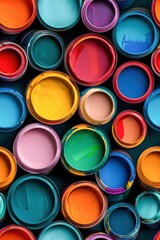 Fototapeta premium Colorful Cups Stack. Vibrant ceramic bowls and cups stacked in two rows, ranging from transparent to opaque shades of orange, pink, green, and blue.