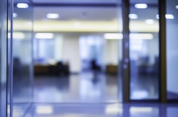 Blurry office space with a modern glass door