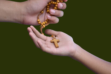 Isolated Christian cross necklace on hands, copy space, clipping paths.