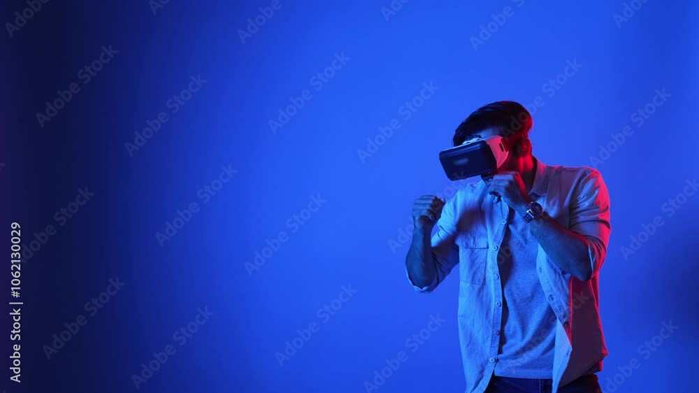 Poster skilled gamer making a punching posture by using virtual reality technology. side view of smart male