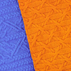 Abstract knitted two-tone background in blue and orange. Large knitted fabric with a pattern. Close-up of knitted blanket. Copy space