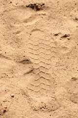 This is a close up view of a pile of sand with visible footprints in it