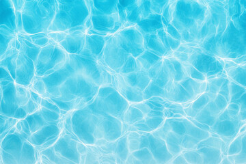 Clear blue water rippling under sunlight creates a serene pool atmosphere