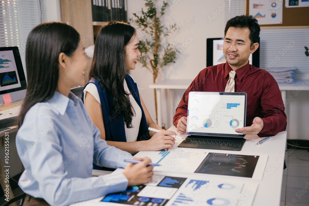 Aufkleber Business team analyzing financial charts and graphs displayed on a tablet and printed documents, collaborating on data analysis and strategic decision-making in a modern office environment