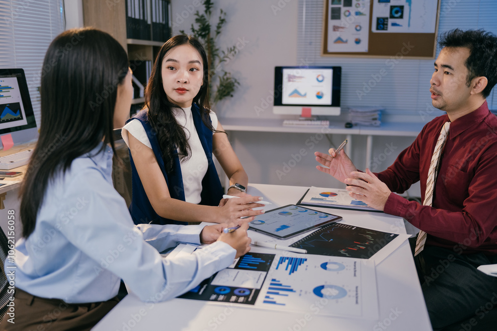 Poster asian businesspeople discussing company performance and analyzing charts and graphs on digital table
