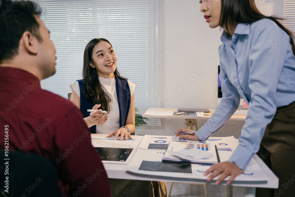 Sticker Asian businesswomen and businessman analyzing financial data, discussing charts and graphs during a meeting in modern office, collaborating on business strategies and planning