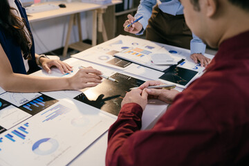Business team analyzing financial charts and graphs discussing company growth and planning...
