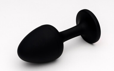 Black anal plug with a pink gem, crafted for adult pleasure