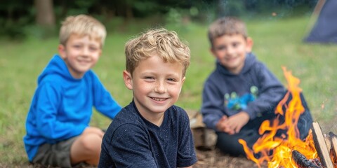 Three kids enjoying a campfire in a forest during a summer camping trip.