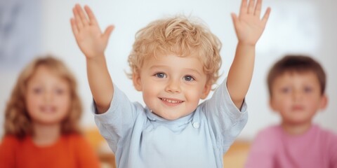 Happy child raising hands in joyful expression, smiling at the camera.